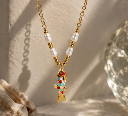 Rainbow Fish Necklace with colorful enamel fish charm, pearl accents, and PVD gold stainless steel chain.