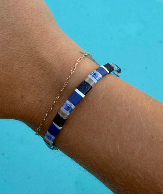 Close-up of the Spotted Eagle Ray bracelet’s blue, black, white, and iridescent glass-bead pattern.