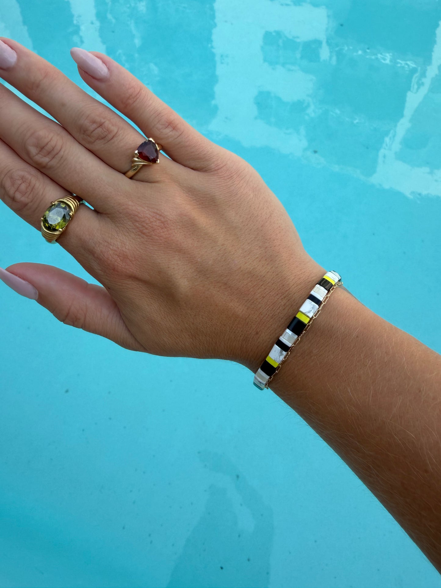 Moorish Idol-inspired glass-bead bracelet worn on a wrist.