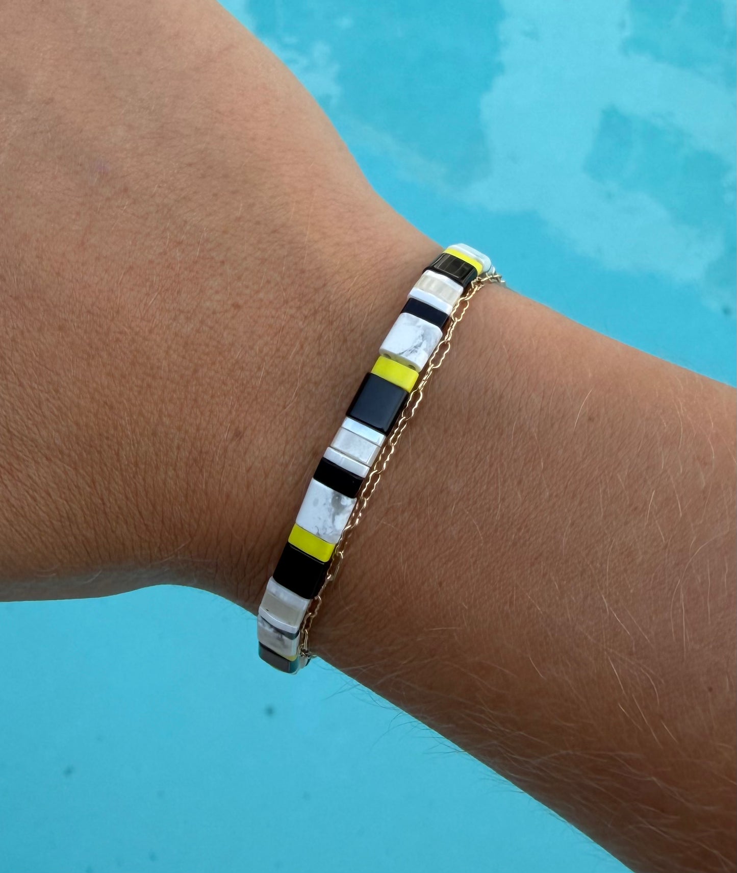 Close-up of the Moorish Idol bracelet’s black, white, and yellow glass-bead pattern.