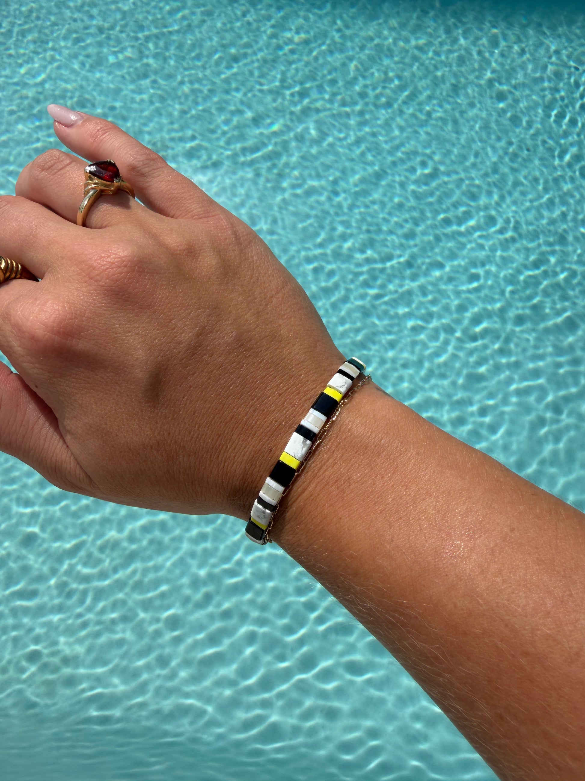 Handmade Moorish Idol bracelet featuring black, white, and bright yellow glass beads.