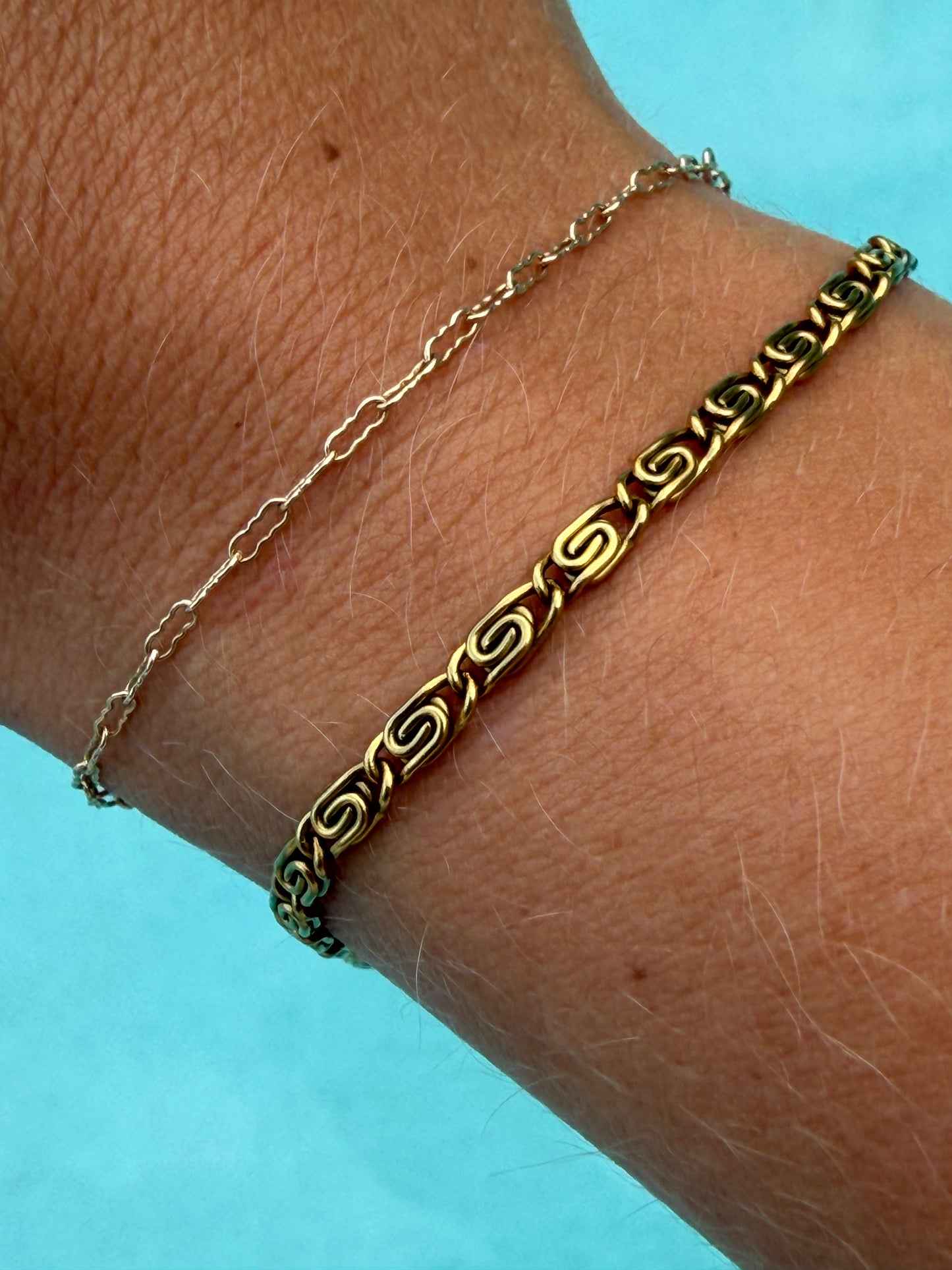 Gold Whirlpool Bracelet with spiral chain links worn on the wrist.