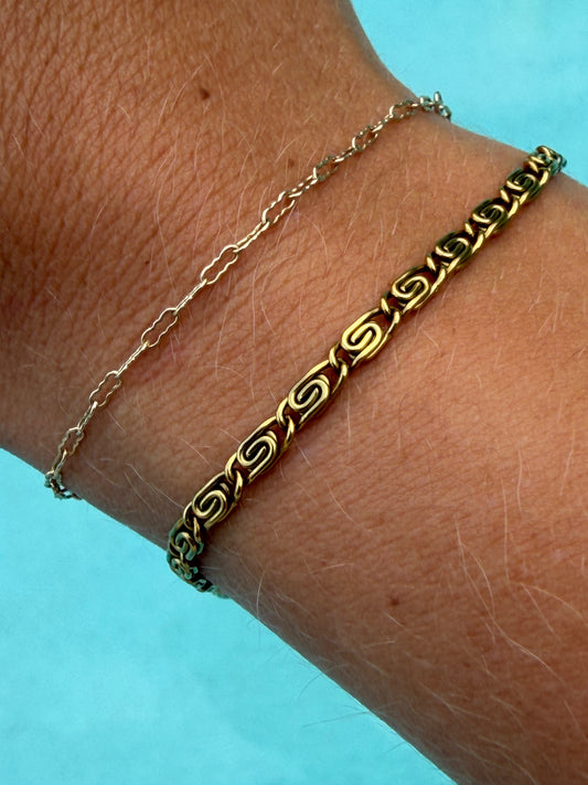 Gold Whirlpool Bracelet with spiral chain links worn on the wrist.