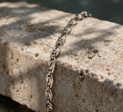 Silver Whirlpool Bracelet with delicate spiral links in an ocean-inspired swirl pattern.